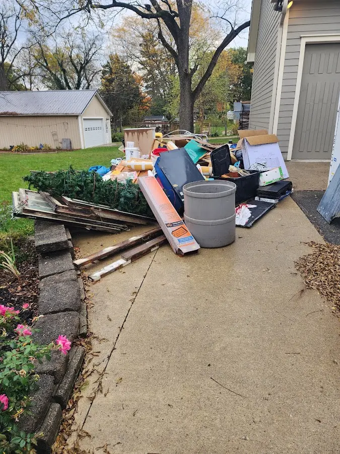 Dumpster being loaded with debris for Estate Cleanout Dumpster Rental in De Queen